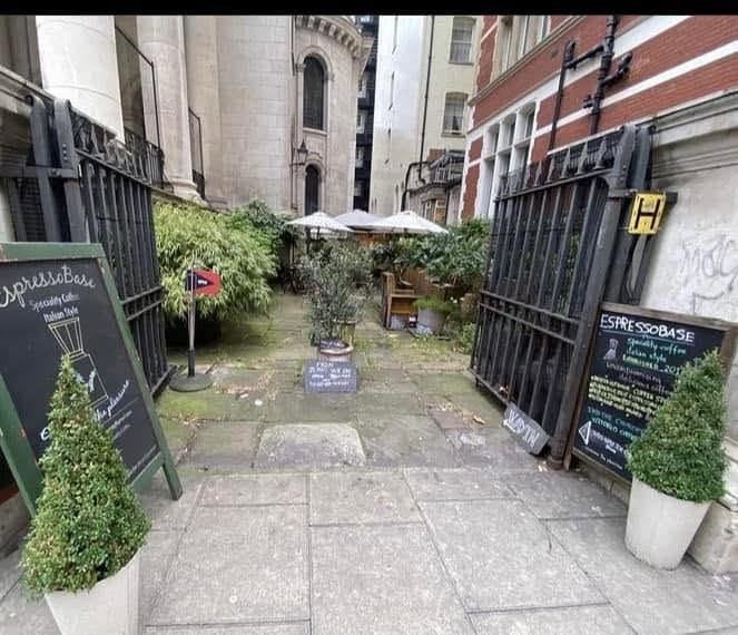 The gated path into St George's churchyard garden
